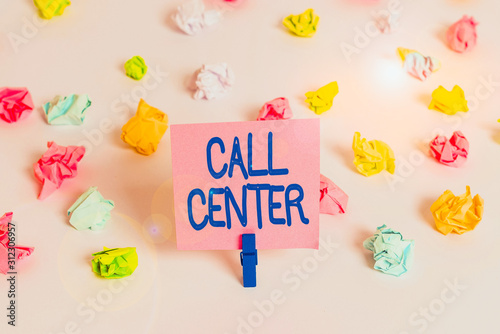 Writing note showing Call Center. Business concept for an office in which large numbers of telephone calls are handled Colored crumpled paper empty reminder white floor clothespin © Artur
