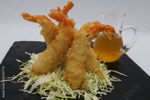 Fried prawn on Shredded cabbage with sweet sauce on black plate