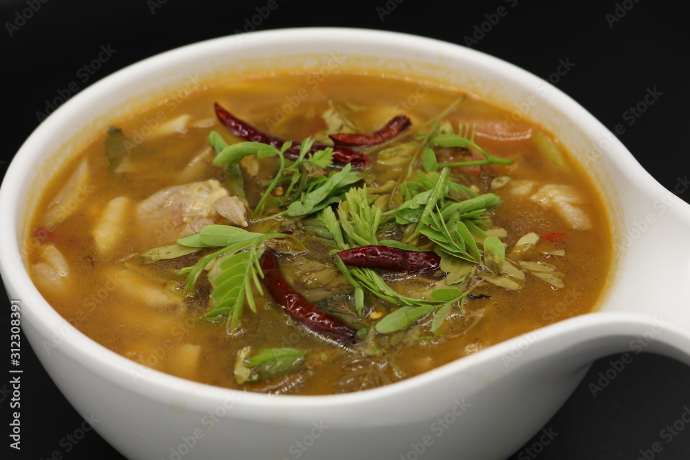 Spicy Thai herb soup with boiled chicken and mushroom Spicy Thai herb soup with boiled chicken and mushroom