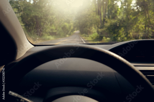 Driver on the steering wheel inside of a car