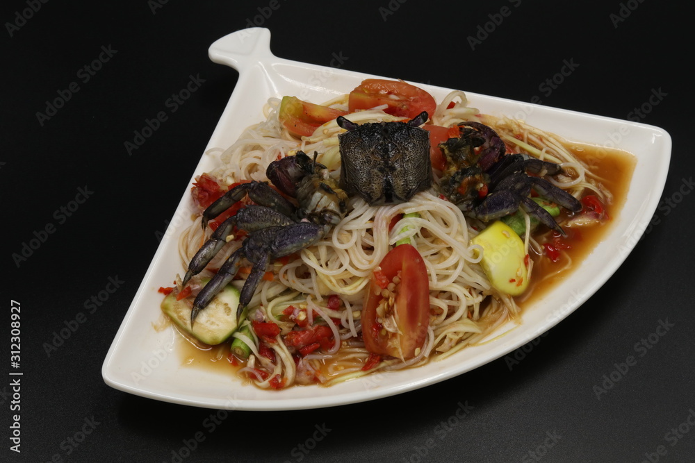 Fototapeta premium Thai spicy salad with black crab in white plate