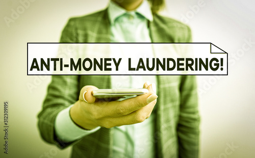 Handwriting text Anti Money Laundering. Conceptual photo regulations stop generating income through illegal actions Business concept with mobile phone and business woman photo