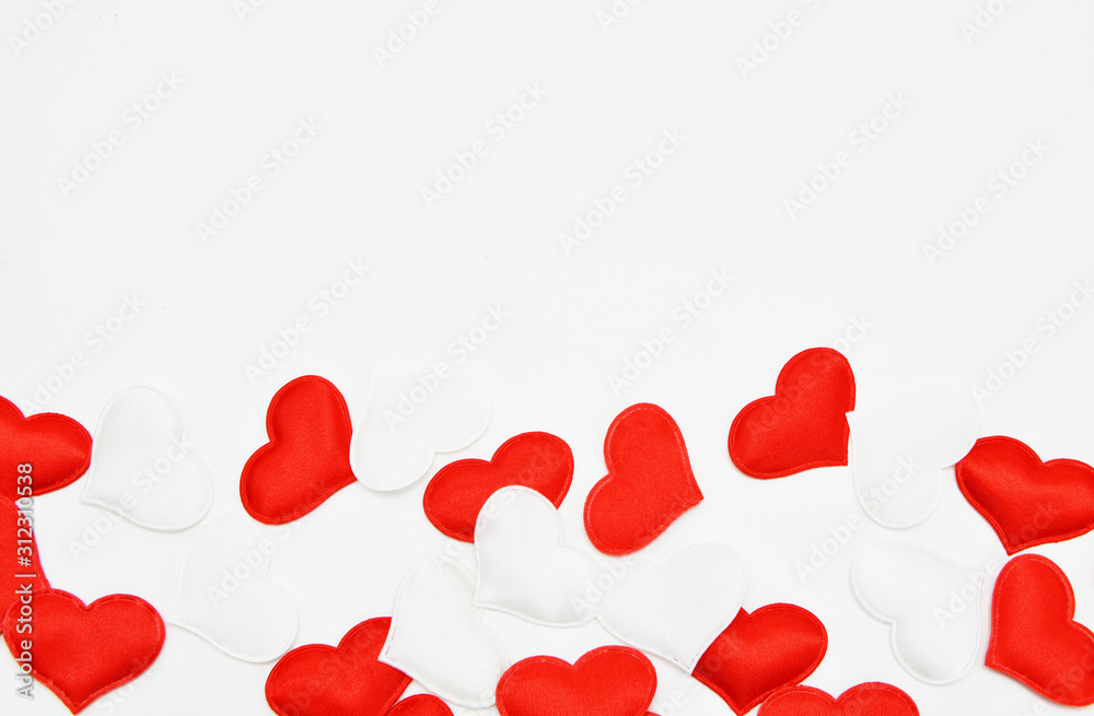 Red and white fabric hearts on a white background. Theme for Valentine's Day and holidays