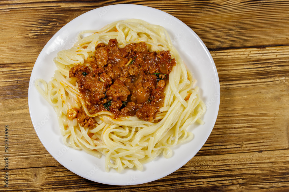 Pasta with bolognese sauce on wooden table Pasta with bolognese sauce on wooden table