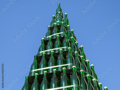 Christmas tree of bottles of champagne. Creative from bottles. Empty bottles of champagne photo