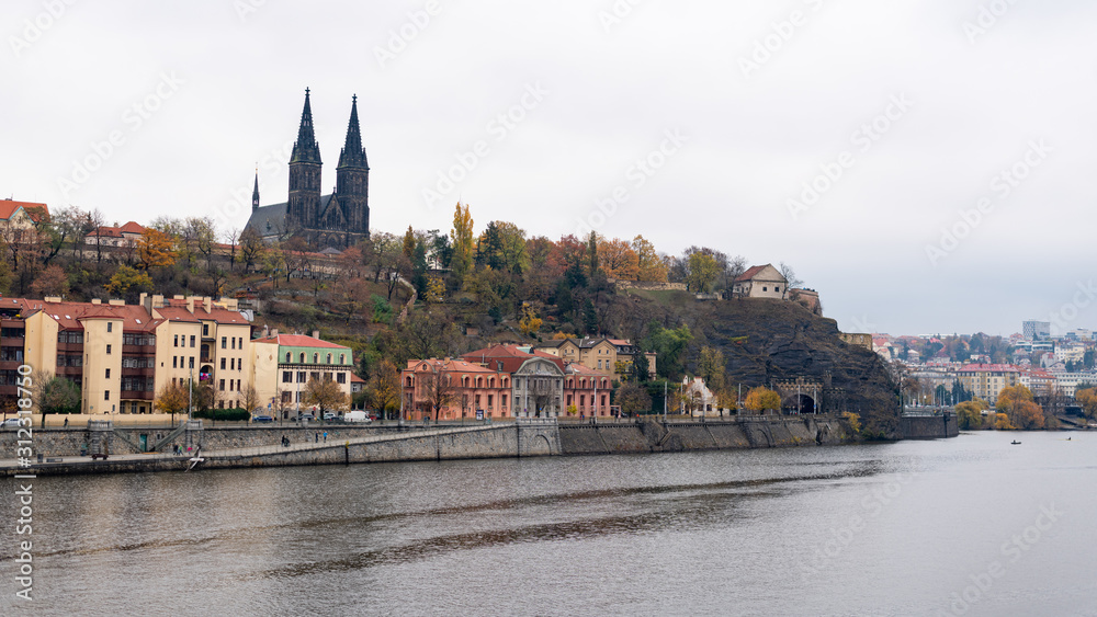 Fort Vysehrad with cathedral of Saint Peter and Saint Paul near river Vltava on a cloudy day in autumn