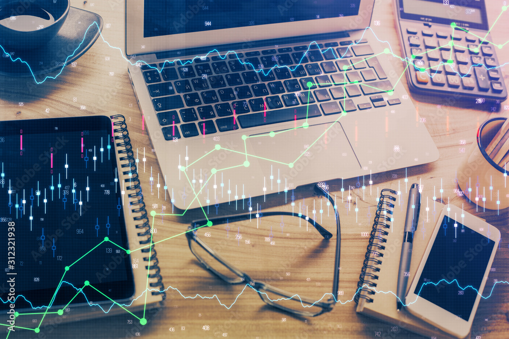 Double exposure of graph and financial info and work space with computer background. Concept of international online trading. Double exposure of graph and financial info and work space with computer background. Concept of international online trading.