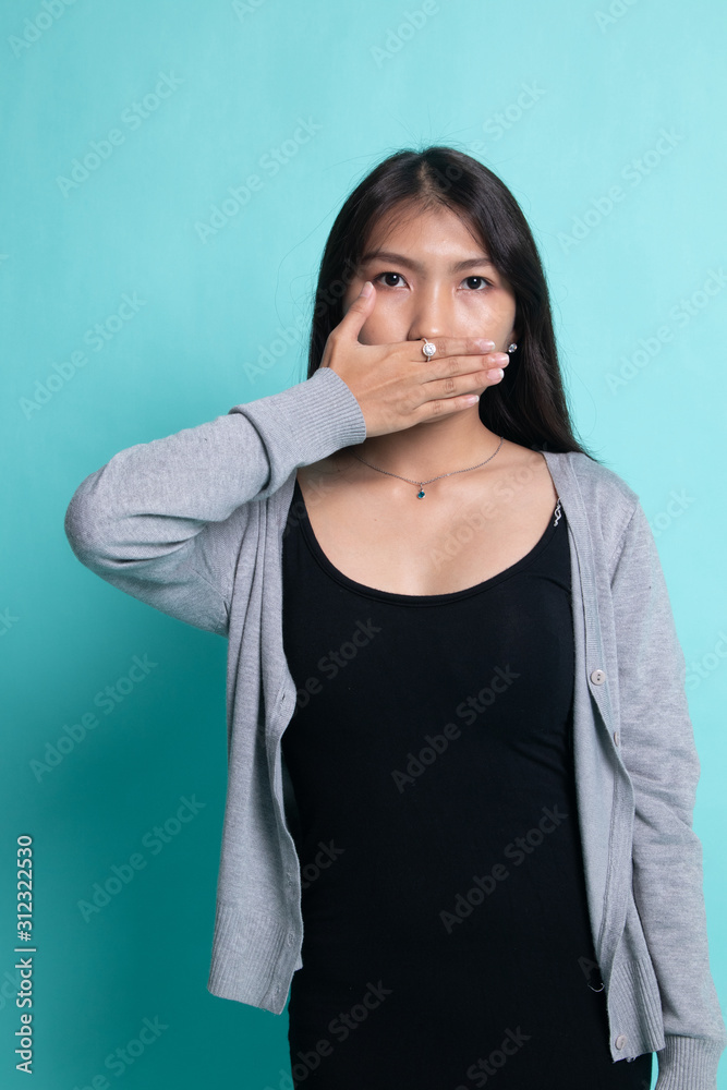 Young Asian woman close her mouth with hand. Young Asian woman close her mouth with hand.