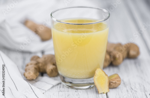 Some fresh Ginger Drink (selective focus; close-up shot)