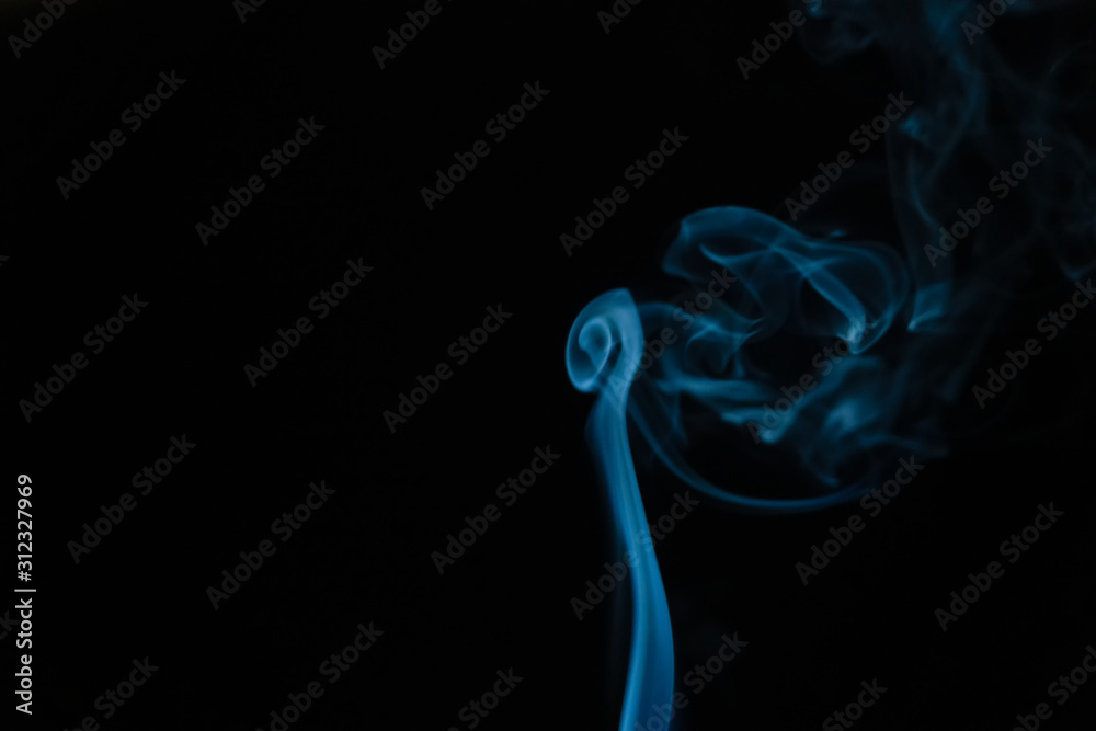 Beautiful abstract blue smoke with copy space on black background. Smoke background for art design or drawing. Abstract figure of the smoke Beautiful abstract blue smoke with copy space on black background. Smoke background for art design or drawing. Abstract figure of the smoke