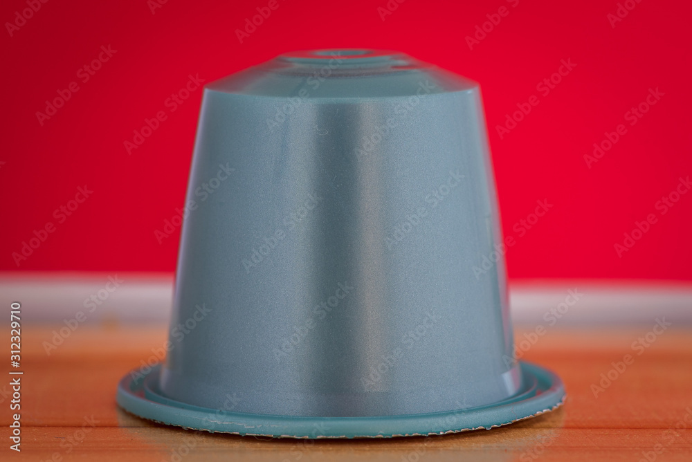 closeup lateral view of an aromatic, tasty espresso coffee capsule closeup lateral view of an aromatic, tasty espresso coffee capsule