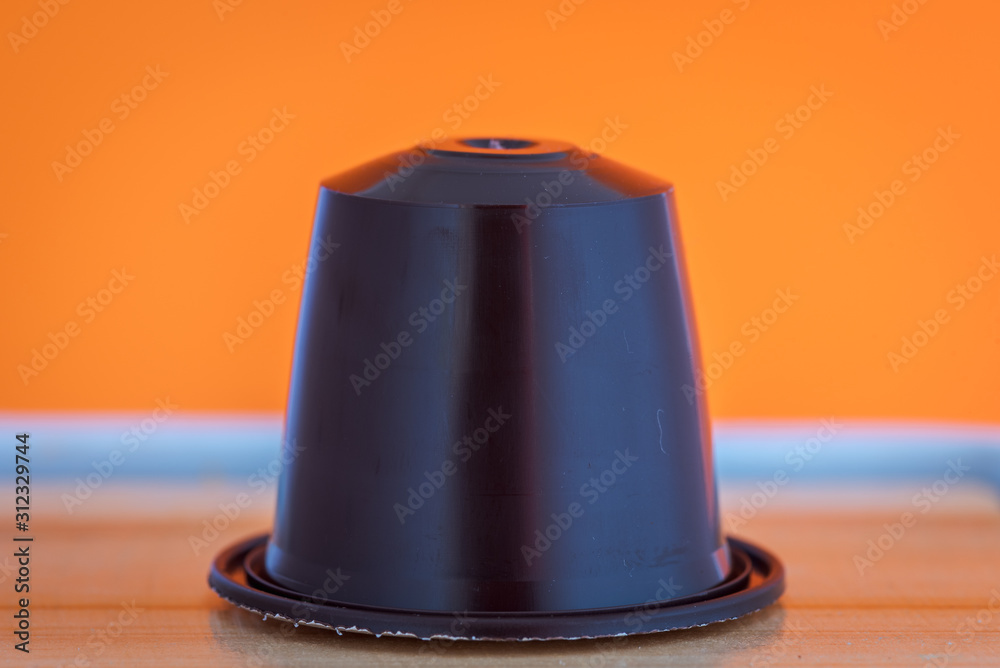 closeup lateral view of an aromatic, tasty espresso coffee capsule closeup lateral view of an aromatic, tasty espresso coffee capsule