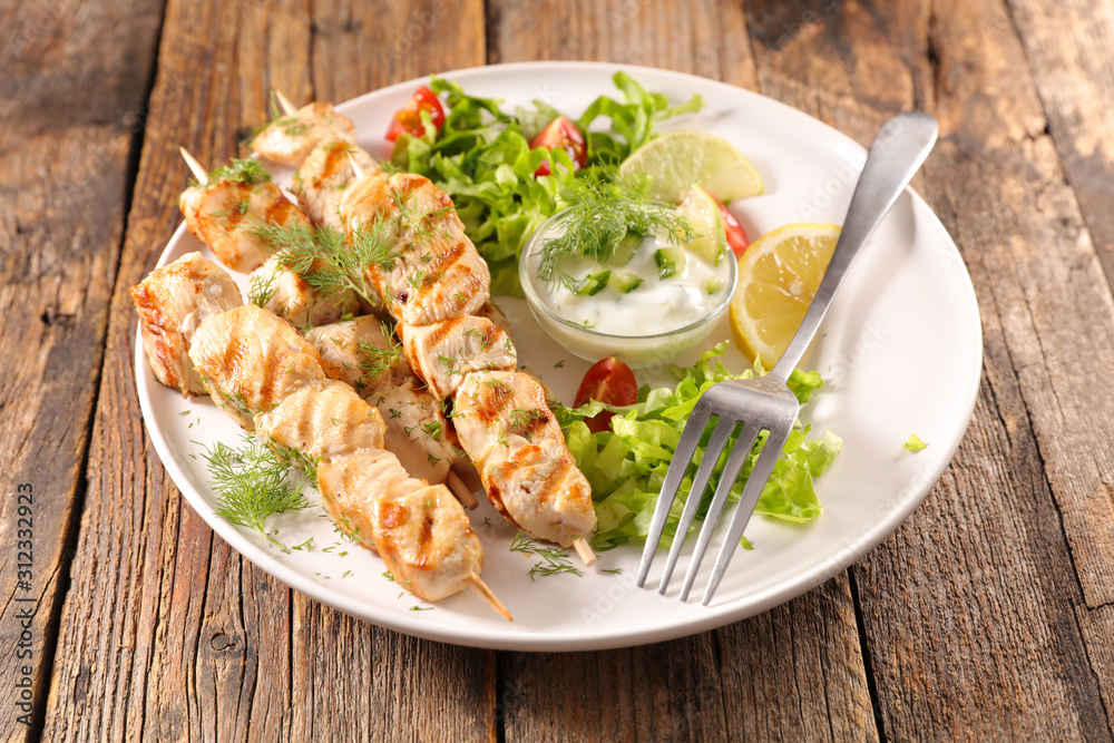 fried chicken skewer with salad and sauce fried chicken skewer with salad and sauce