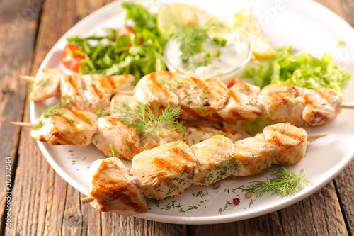 fried chicken skewer with salad and sauce