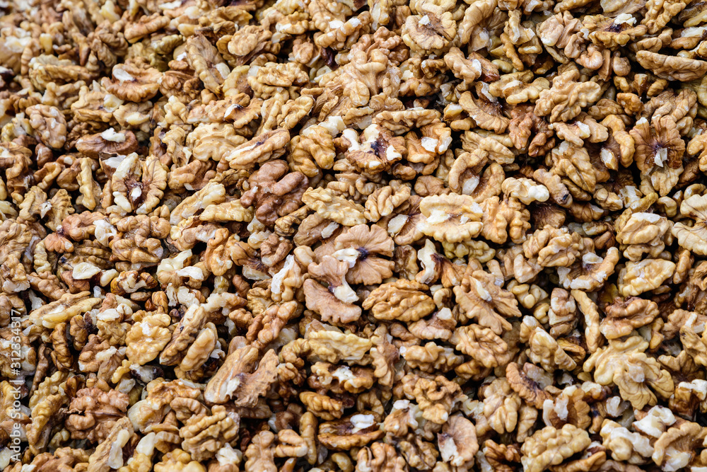 Large group of fresh walnut kernels sold at a spice food market, organic food background Large group of fresh walnut kernels sold at a spice food market, organic food background