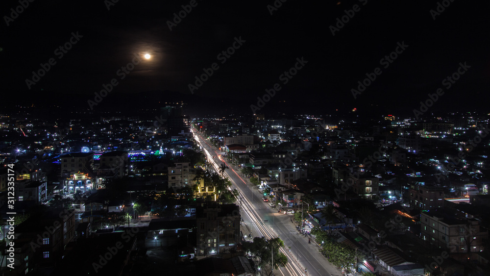 Fototapeta premium Cityscape of downtown in Myanmar at night with traffic light 