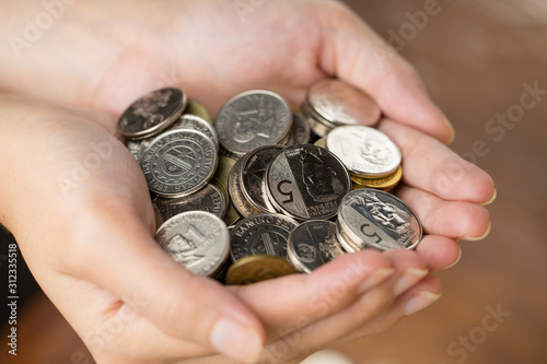 Bunch of Philippines peso coins on woman's hand