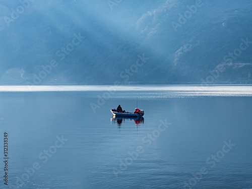 Single fisherman's boat on Lake Como