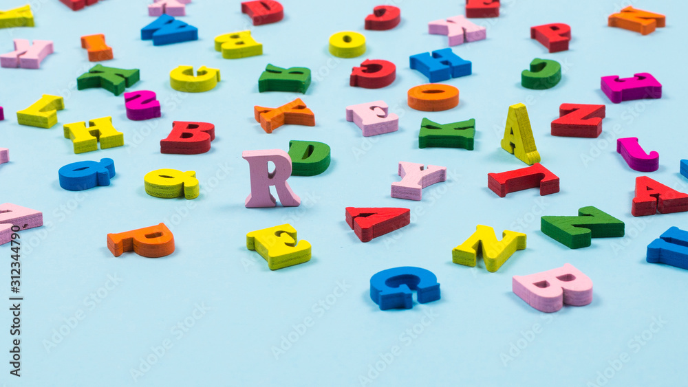 Multicolored letters on a blue background. Multicolored letters on a blue background.
