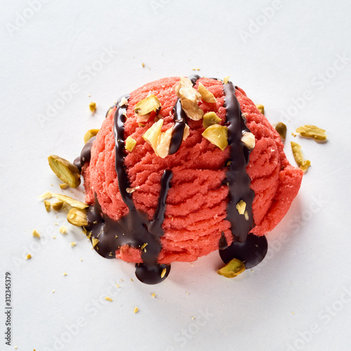 Red berry ice-cream topped with pistachio nuts