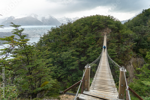 Hiker on Long Suspension Bridge