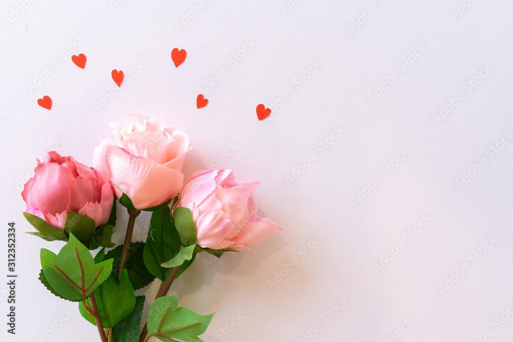 close up top view group of pastel roses on soft pink color background with mini heart for mother's day and valentine day  design concept