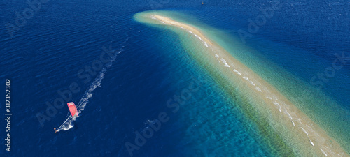 Aerial drone ultra wide photo of kite surfer practising in exotic turquoise sand bar