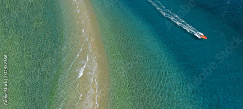 Aerial drone ultra wide photo of inflatable speed boat cruising in tropical exotic destination