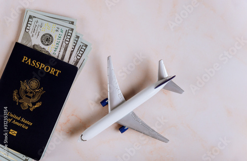 USA passport and dollar banknotes with model airplane, traveling for preparation airplane