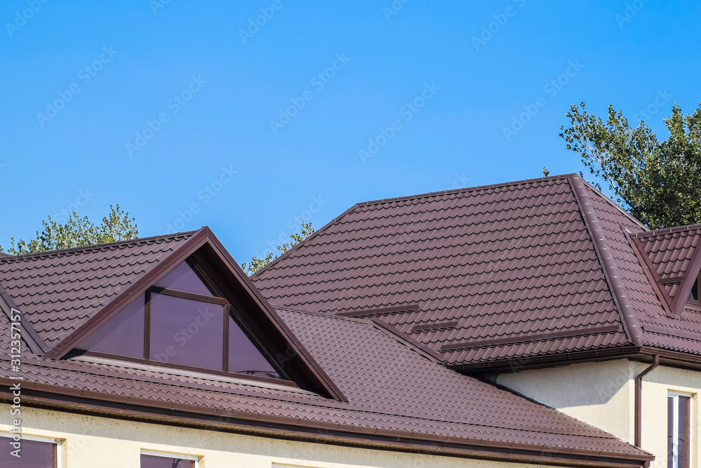 House with plastic windows and a brown roof of corrugated sheet