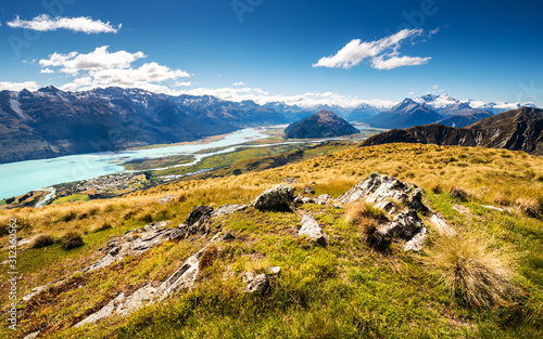 Panoramic view of Glenorchy with Lake Wakatipu and snowy mountains. Scenic lookout with beautiful valley, river and mountains.