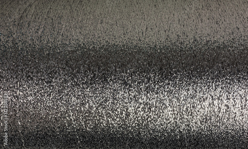 background of silver lurex wool on a cone