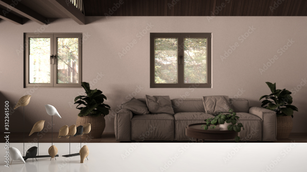 White table top or shelf with minimalistic bird ornament, birdie knick - knack over blurred contemporary country living room with sofa and carpet, modern interior design White table top or shelf with minimalistic bird ornament, birdie knick - knack over blurred contemporary country living room with sofa and carpet, modern interior design