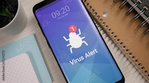 Smartphone showing a virus found notification banner appearing on the lock screen. Mobile phone alerting the user. photo