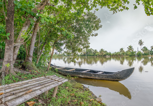 Boat and Bench on Island in Kerala Backwaters photo