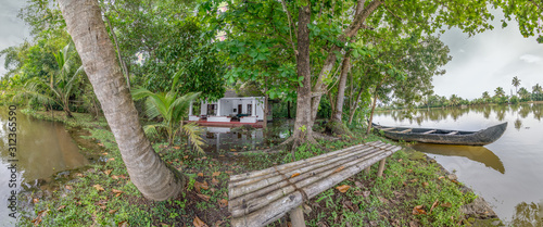 Boat and Bench on Island in Kerala Backwaters photo