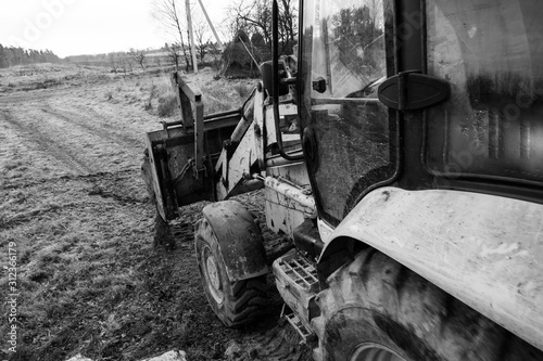 Excavator with a large iron bucket on a construction site during road works  Backhoe dig the ground for the foundation.