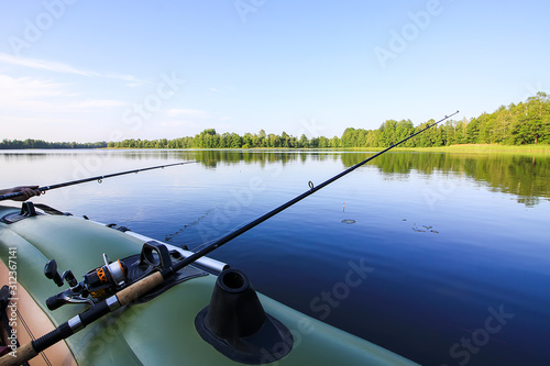 Spinning with reel on evening lake background
