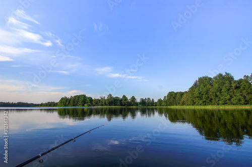 Scenic view to landscape with lake in Latvia, East Europe. Summer nature. Fishing rod. 