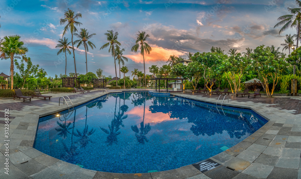 Swimming Pool with Palms at Sunset