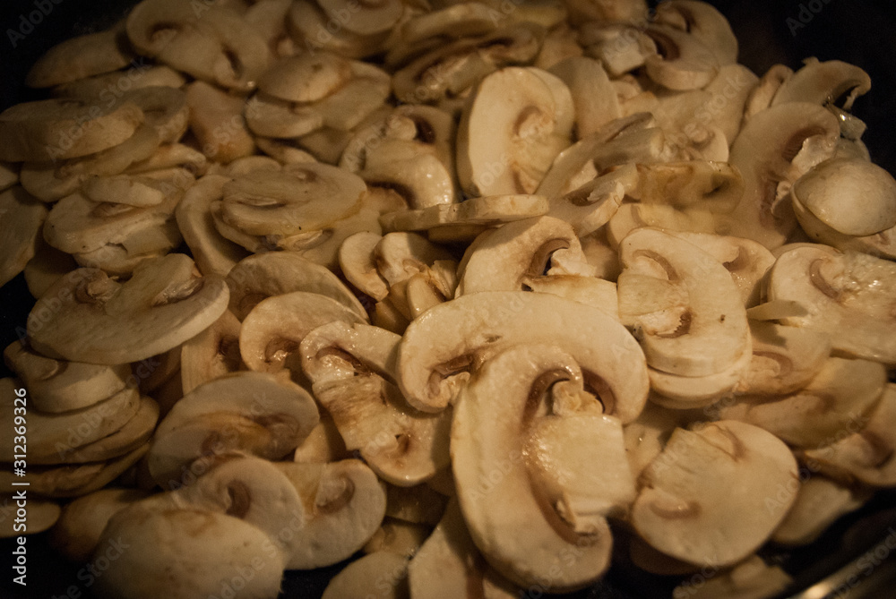 lot of sliced mushroom cooking in the pan lot of sliced mushroom cooking in the pan