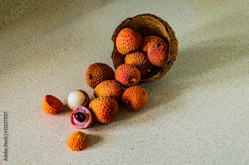 Fresh and ripe lychees that fallen out of coconut shell