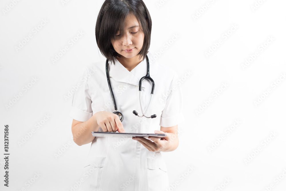 Young asian nurse with a stethoscope using a digital tablet, isolated over white background. Young asian nurse with a stethoscope using a digital tablet, isolated over white background.