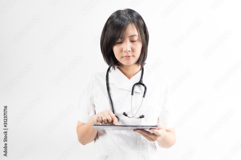 Young asian nurse with a stethoscope using a digital tablet, isolated over white background. Young asian nurse with a stethoscope using a digital tablet, isolated over white background.