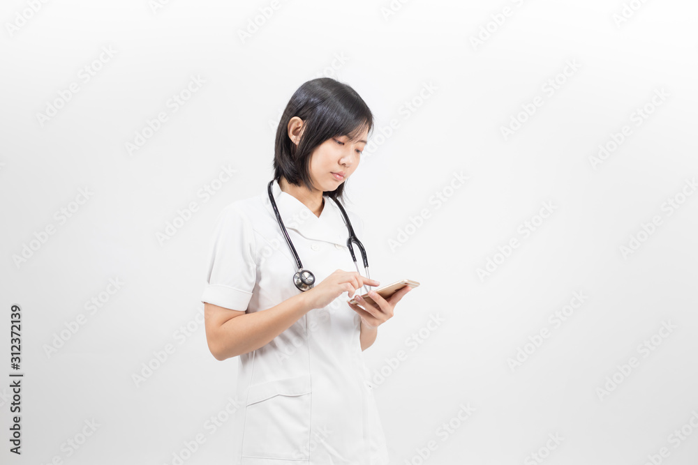 Young asian nurse with a stethoscope talking on the phone, isolated over white background. Young asian nurse with a stethoscope talking on the phone, isolated over white background.