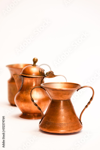 Series of little decorative copper artisan objects isolated on white background - photography