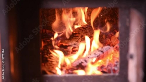 Fire in the classic russian bathhouse furnace. Tipical village life