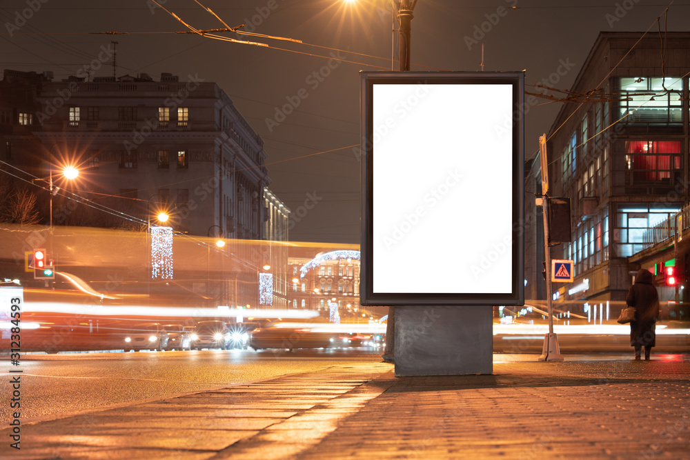 Vertical advertising billboard urban. city format in the night city. Luminous advertising field Mockup in town. Driving blurry cars nearby - obrazy, fototapety, plakaty 