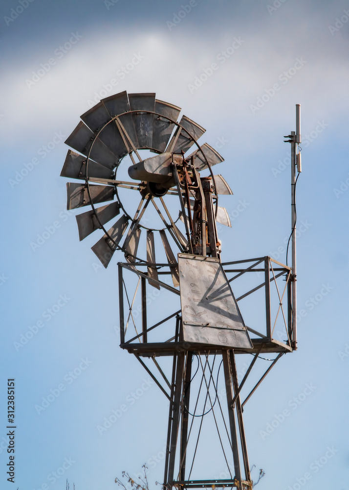 old windmill against blue sky