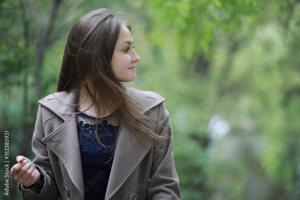 Young girl in a coat in a spring park Young girl in a coat in a spring park